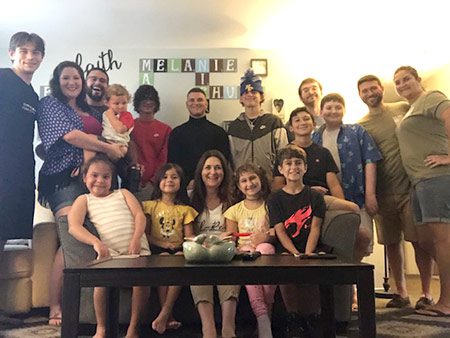 Joy and her large family pose for a photo together